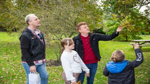 A family exploring the autumn colours and autumn trail at Northumberland's Seaton Delaval Hall